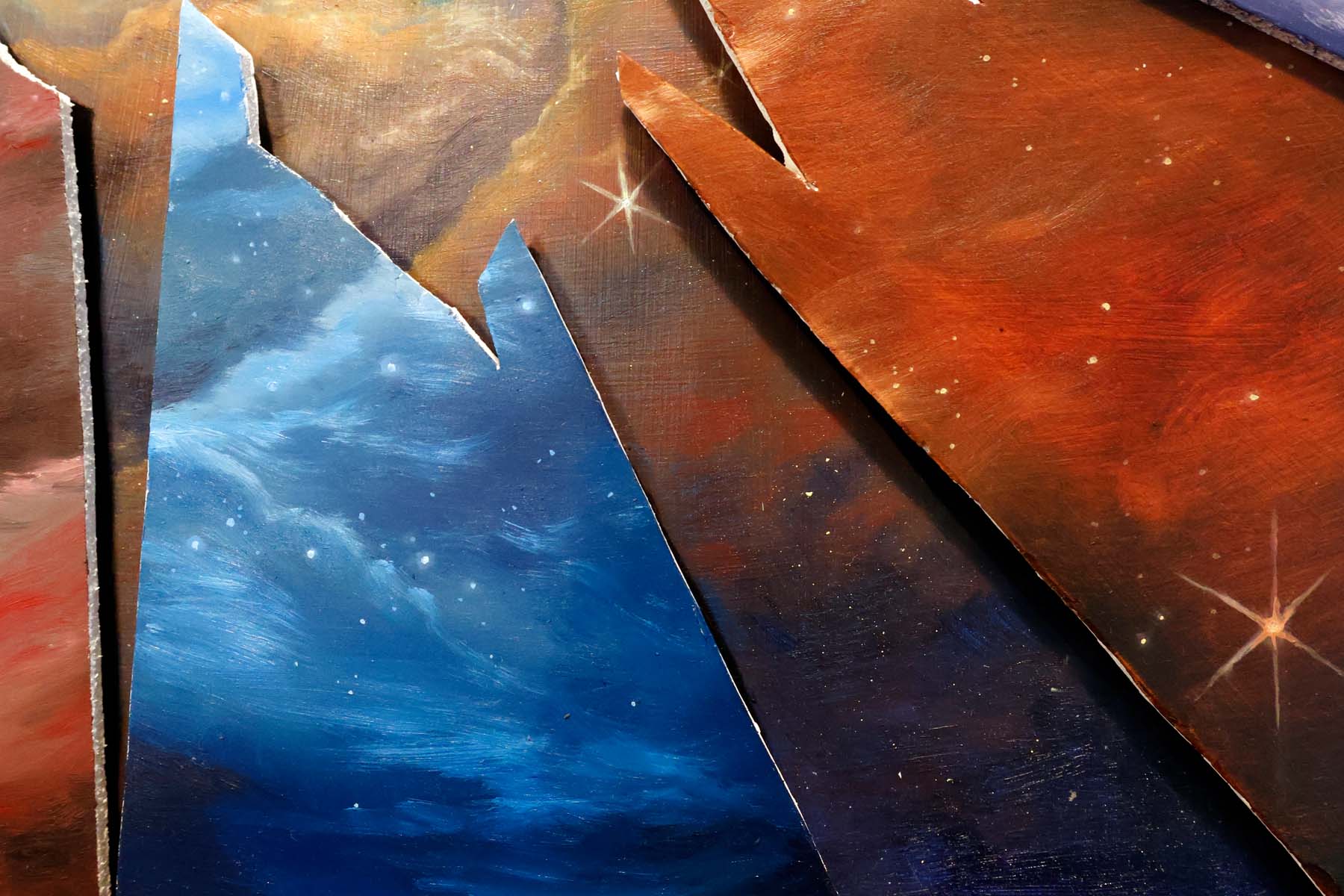 Close up of bottom shards with blue, red and purple color fields, clouds  of dust and stars